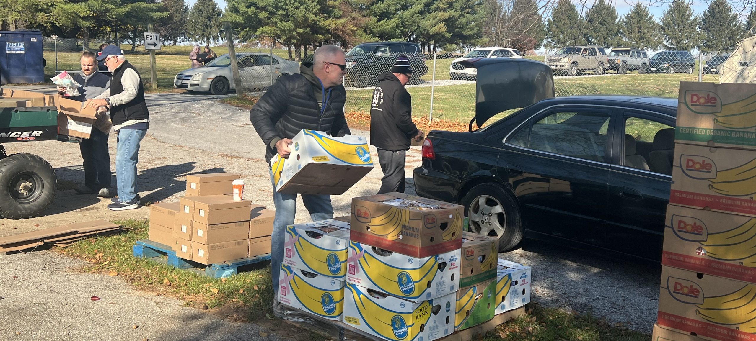 group of people holding food boxes