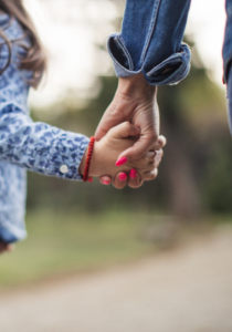 mom and girl holding hands